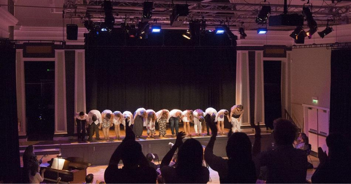 Crowd cheering performers on stage at The Witham, Barnard Castle. 